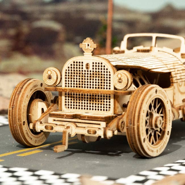 Mellow Monkey 3D laser cut wooden Grand Prix car puzzle, assembled, on a race track display.