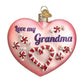 Mellow Monkey Grandma Heart blown glass holiday ornament with candy cane and candy details. Pink glitter.