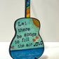 Mellow Monkey Grateful Dead wooden guitar ornament featuring hand-painted lyrics and a colorful fretboard on an easel.