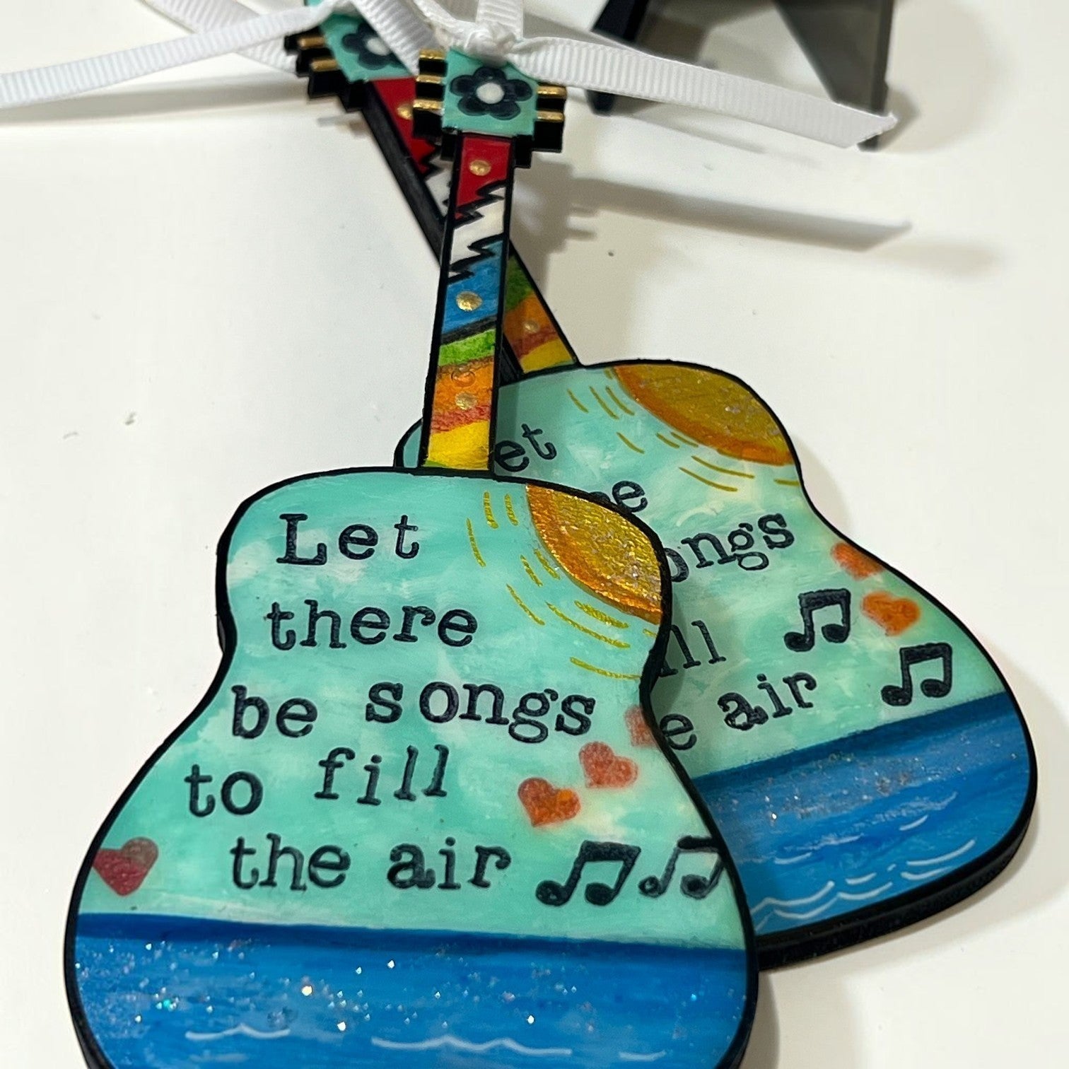 Mellow Monkey Grateful Dead wooden guitar ornament with hand-painted lyrics and musical notes on a white background.