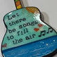 Mellow Monkey hand-painted wooden Grateful Dead guitar ornament featuring lyrics and musical notes on a blue background.