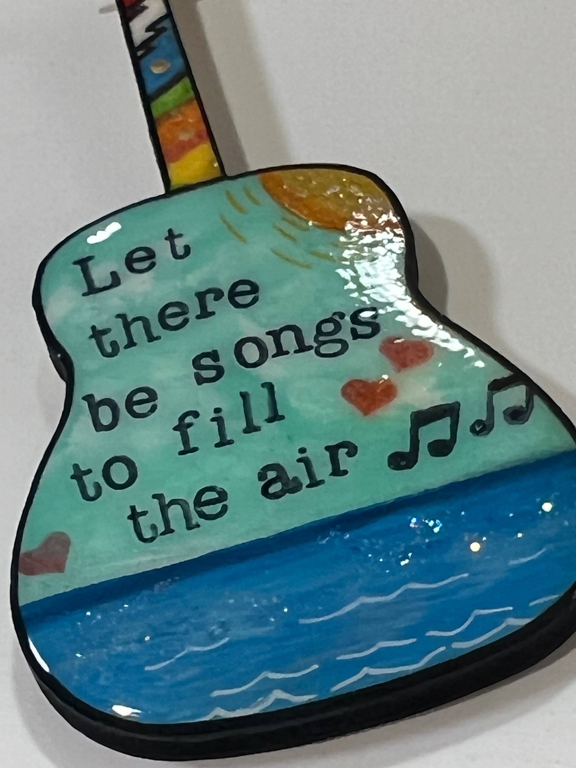 Mellow Monkey hand-painted wooden Grateful Dead guitar ornament featuring lyrics and musical notes on a blue background.