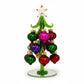 Mellow Monkey 6-inch green glass Christmas tree featuring colorful swirled ornaments and a clear glass star topper.