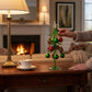 Mellow Monkey 10-inch green glass tabletop Christmas tree with red and plaid ornaments and a gold-tipped star.
