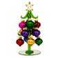 Mellow Monkey 6-inch green glass Christmas tree decorated with vibrant, multi-colored swirled glass ornaments.