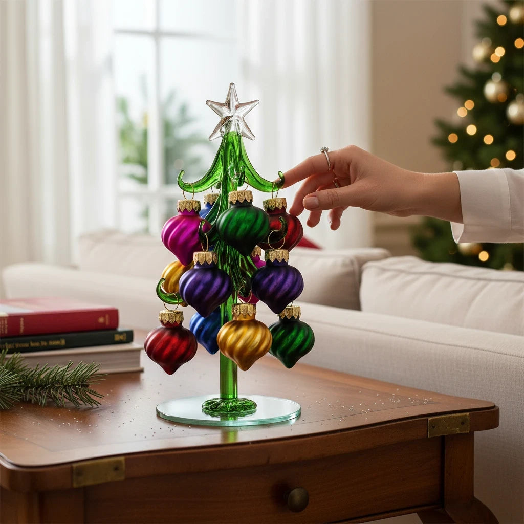Mellow Monkey 6-inch green glass Christmas tree with colorful swirled ornaments on a wooden table
