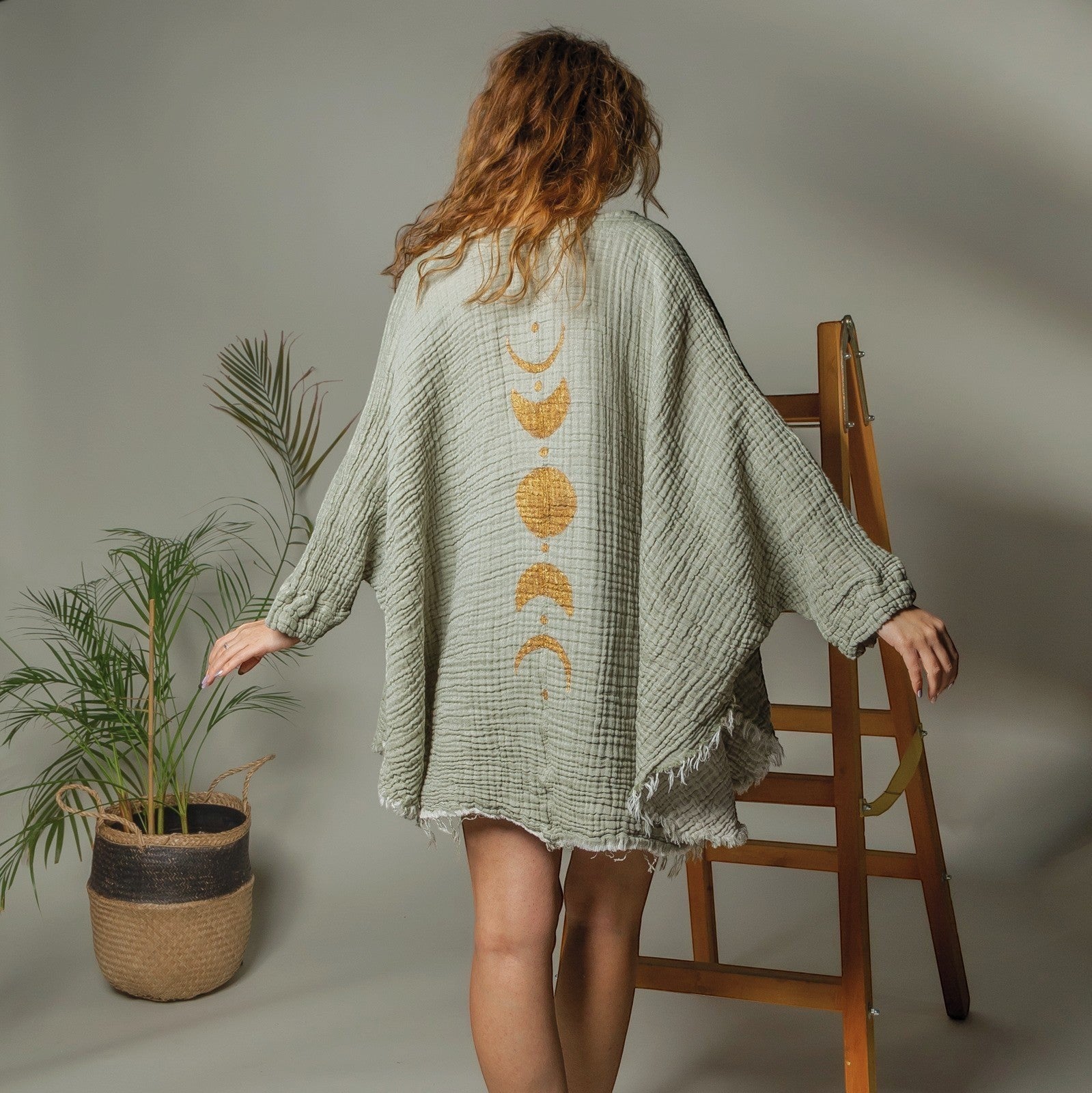 Mellow Monkey green 4-layer muslin kimono robe with gold moon phases design on back, frayed hem.