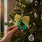 Mellow Monkey mini seaglass wreath ornament in green with a lace bow hanging on a Christmas tree