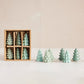 Mellow Monkey set of six small green stoneware tree figurines in a gift box for holiday mantel and table decor.