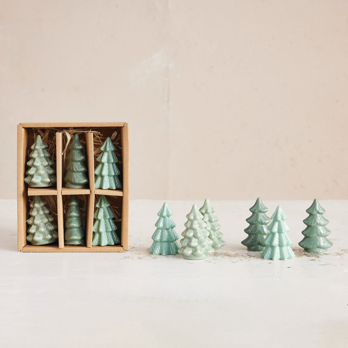 Mellow Monkey set of six small green stoneware tree figurines in a gift box for holiday mantel and table decor.