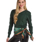 A woman wearing a Mellow Monkey green tartan silky scarf tied at her waist over a dark green sweater and black pants.