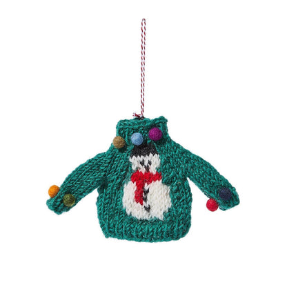 Mellow Monkey hand-crafted green wool sweater ornament featuring a white snowman design and colorful pom-poms.