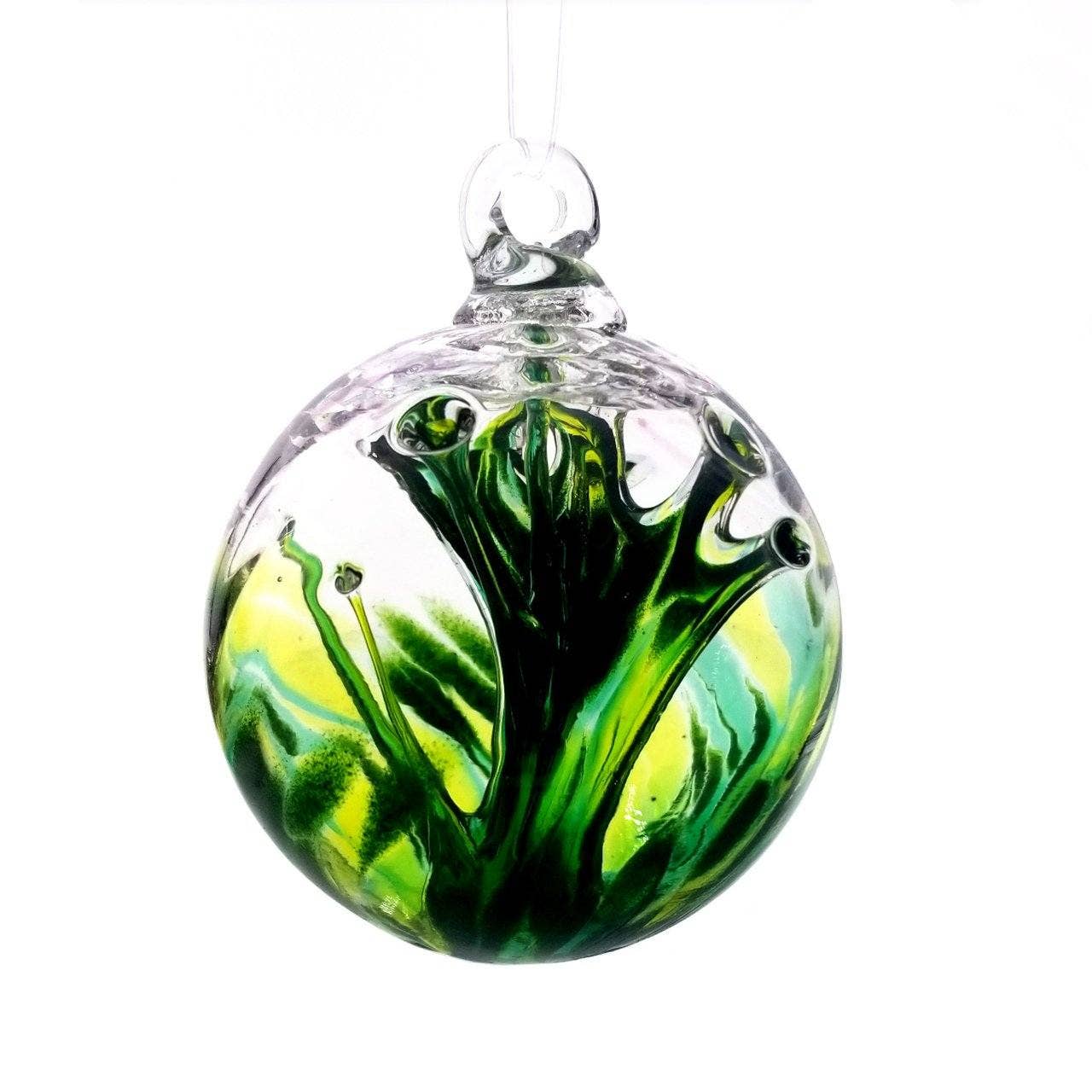 Mellow Monkey 4-inch glass wish ball ornament with swirling green and yellow patterns for window hanging