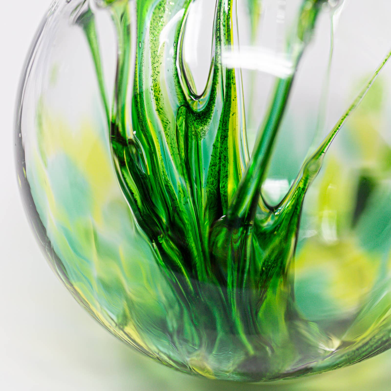 Mellow Monkey 4-inch glass wish ball ornament with swirling green and yellow patterns for window suncatcher display