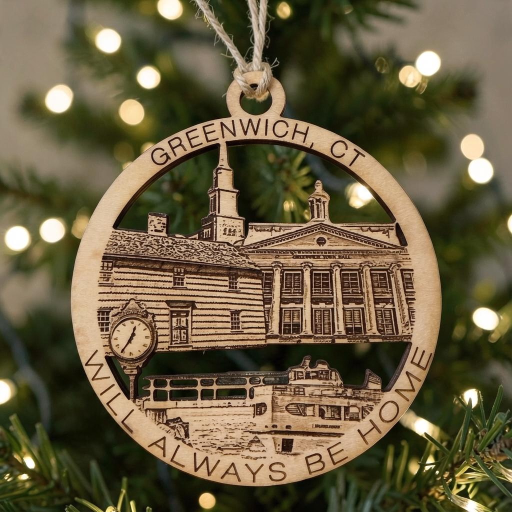 Mellow Monkey round wooden ornament featuring Greenwich CT landmarks and text hanging on a Christmas tree