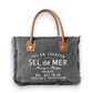 Mellow Monkey Hazy Tones grey canvas and leather crossbody bag with frayed edges and vintage French typography.