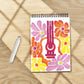 Mellow Monkey Groovy Vibes FlowArt Pogo-Dot kit with a spiral-bound dot art pad and a white pogo marker on wood table