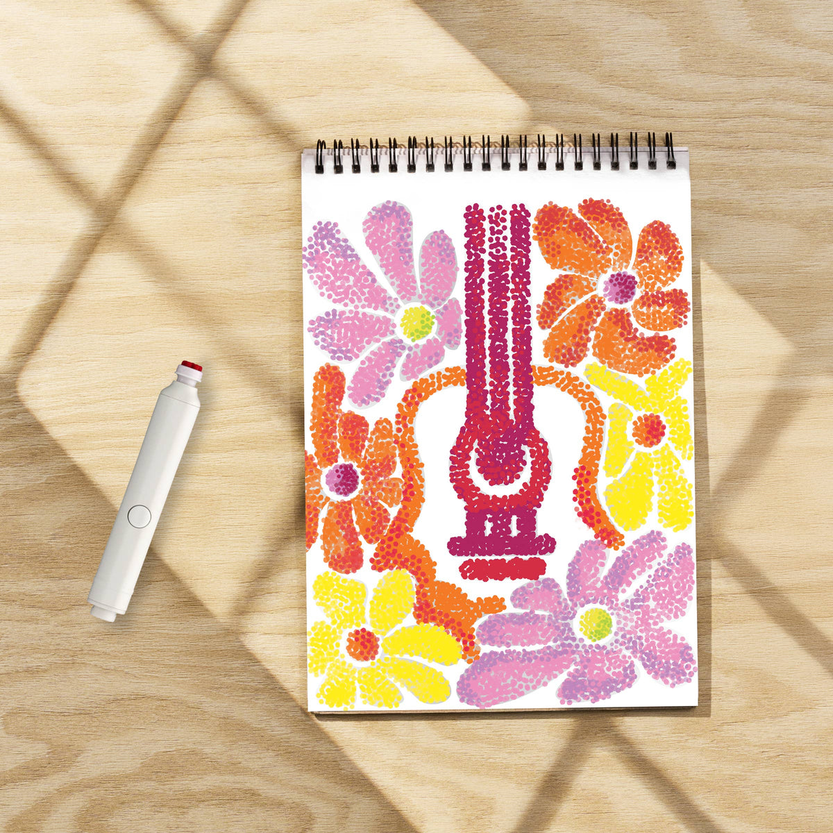 Mellow Monkey Groovy Vibes FlowArt Pogo-Dot kit with a spiral-bound dot art pad and a white pogo marker on wood table