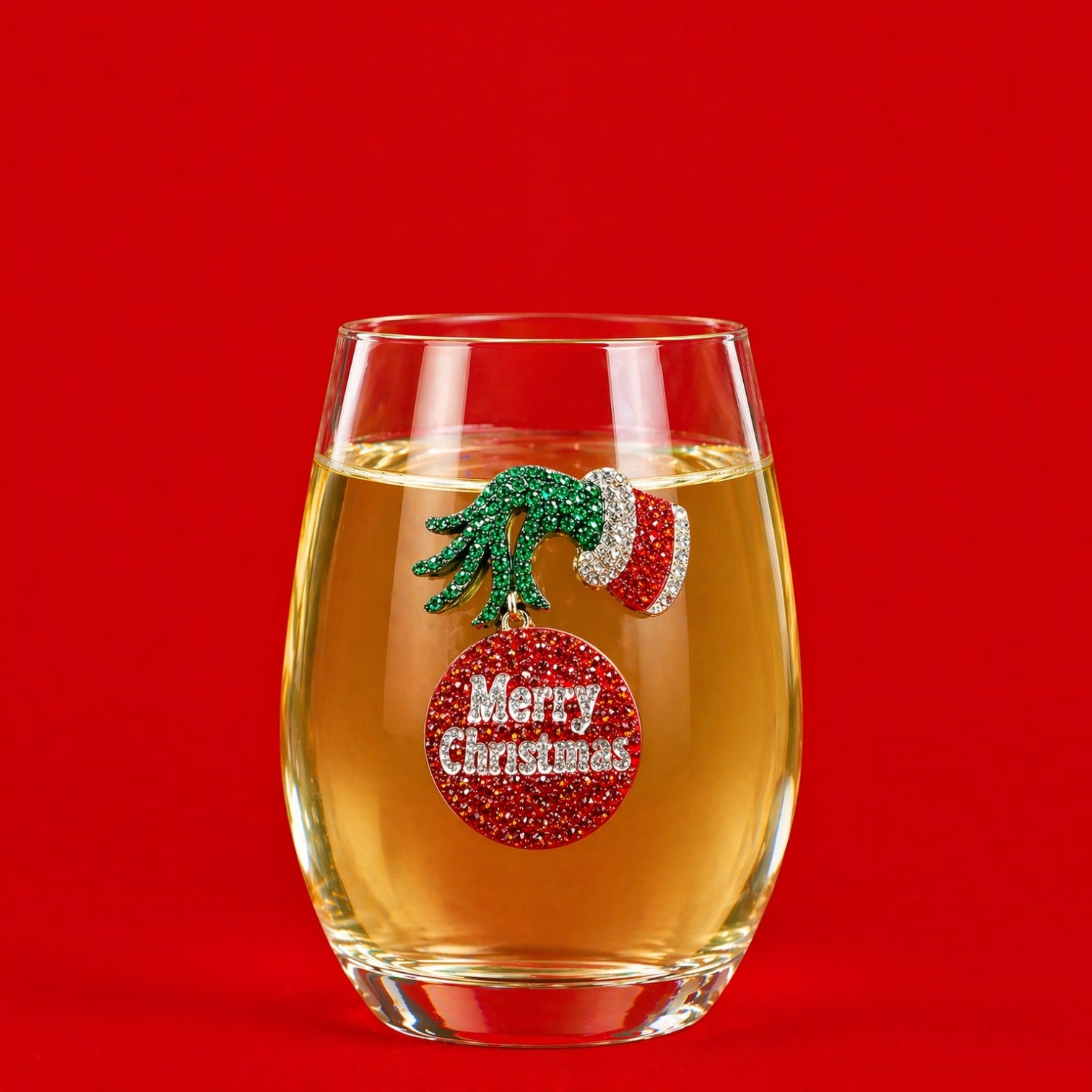 Mellow Monkey stemless wine glass featuring a jeweled Grumpy Christmas hand and Merry Christmas ornament charm