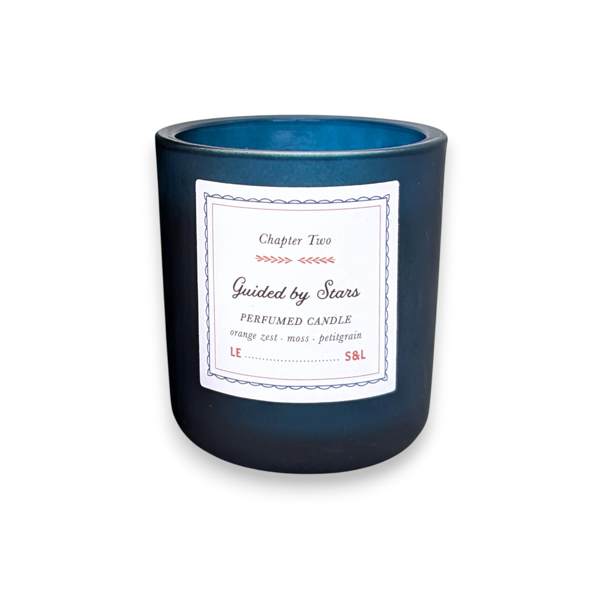 Mellow Monkey Guided by Stars scented candle in a deep midnight blue glass vessel with a storybook-style label.