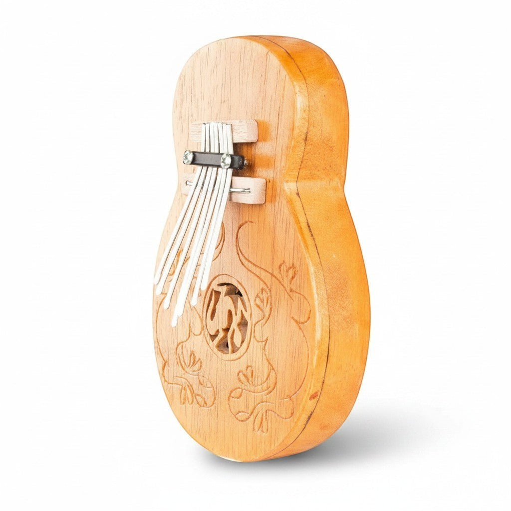 Mellow Monkey Guitar Carimba, a 10" x 5" wooden thumb piano with 7 metal tines and decorative carvings.