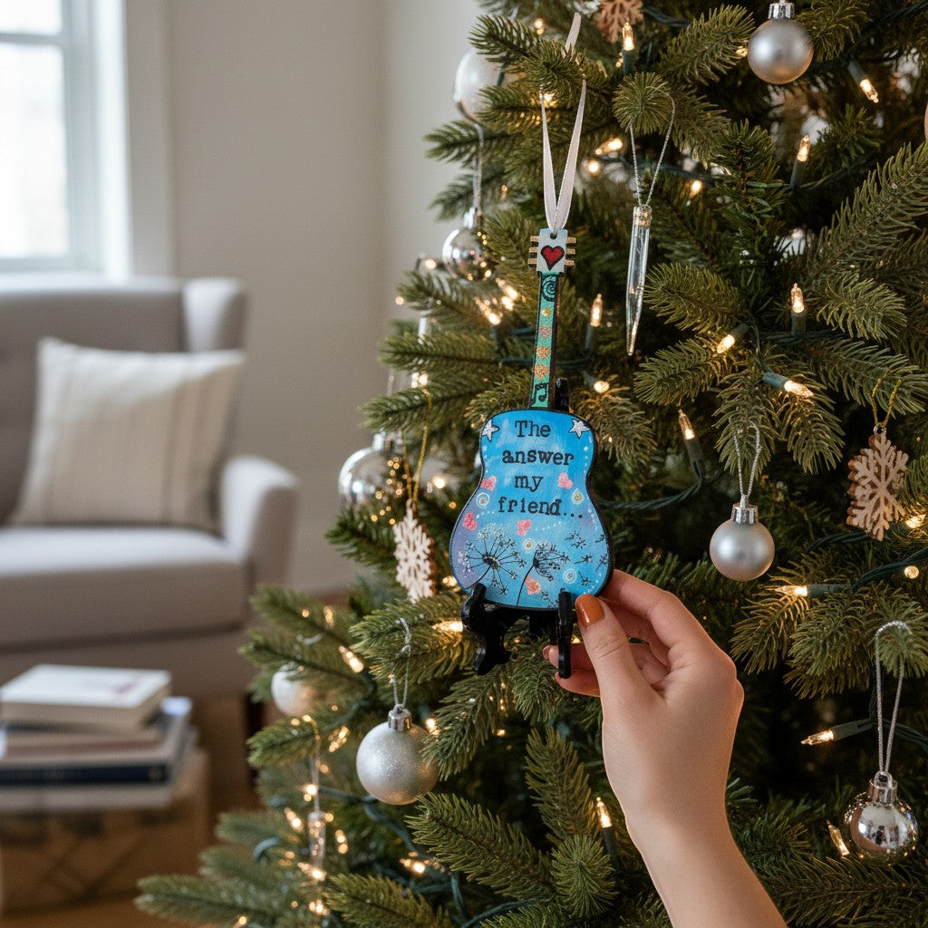 Mellow Monkey hand-painted guitar ornament featuring Bob Dylan lyrics hanging on a decorated Christmas tree