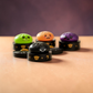 Mellow Monkey Halloween mystery squishy dumplings in green, orange, purple, and black sitting on decorative containers.