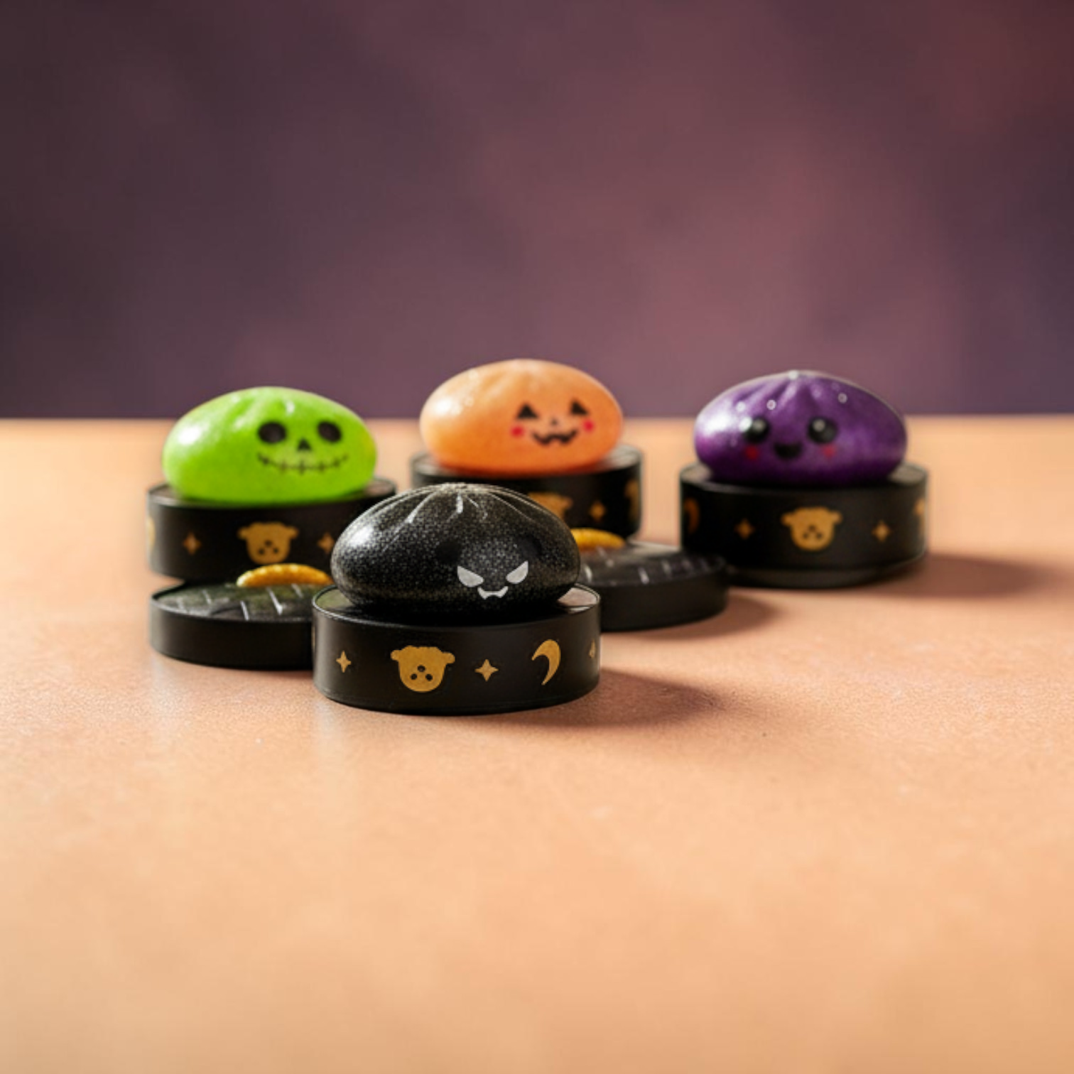 Mellow Monkey Halloween mystery squishy dumplings in green, orange, purple, and black sitting on decorative containers.