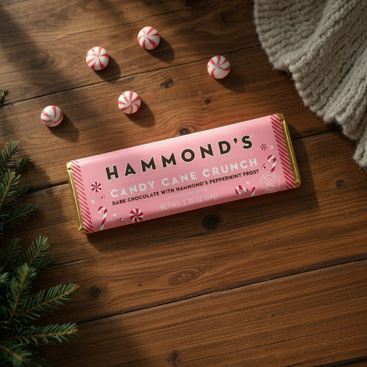Mellow Monkey Hammond's Candy Cane Crunch dark chocolate bar with peppermint pieces on a rustic wooden table.