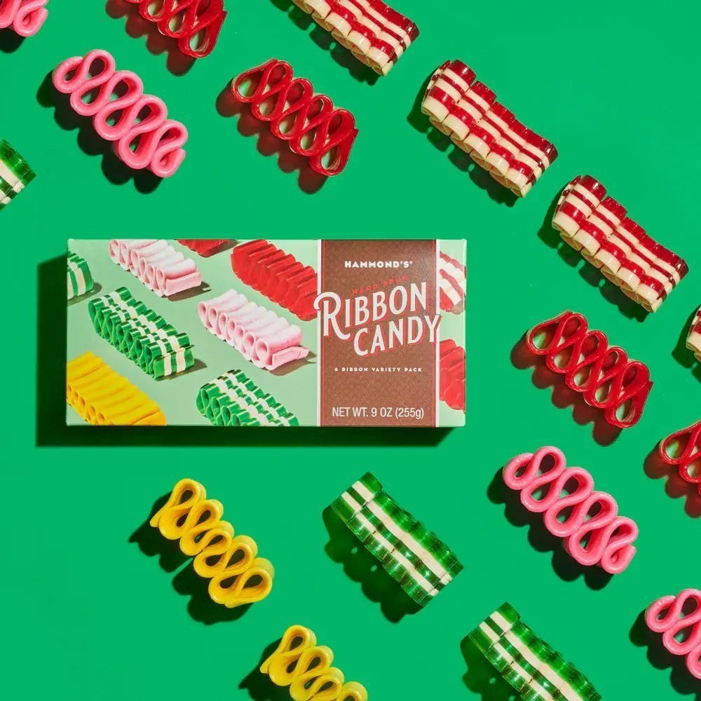 Mellow Monkey Hammond's 9 oz gift box of assorted colorful ribbon candy surrounded by loose pieces on green background