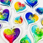 Mellow Monkey hand-blown glass heart ornaments in vibrant multi-colored swirls with gold leaf accents.