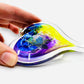 Mellow Monkey hand-blown glass heart ornament featuring vibrant blue, purple, and yellow swirls in a 3-inch size.
