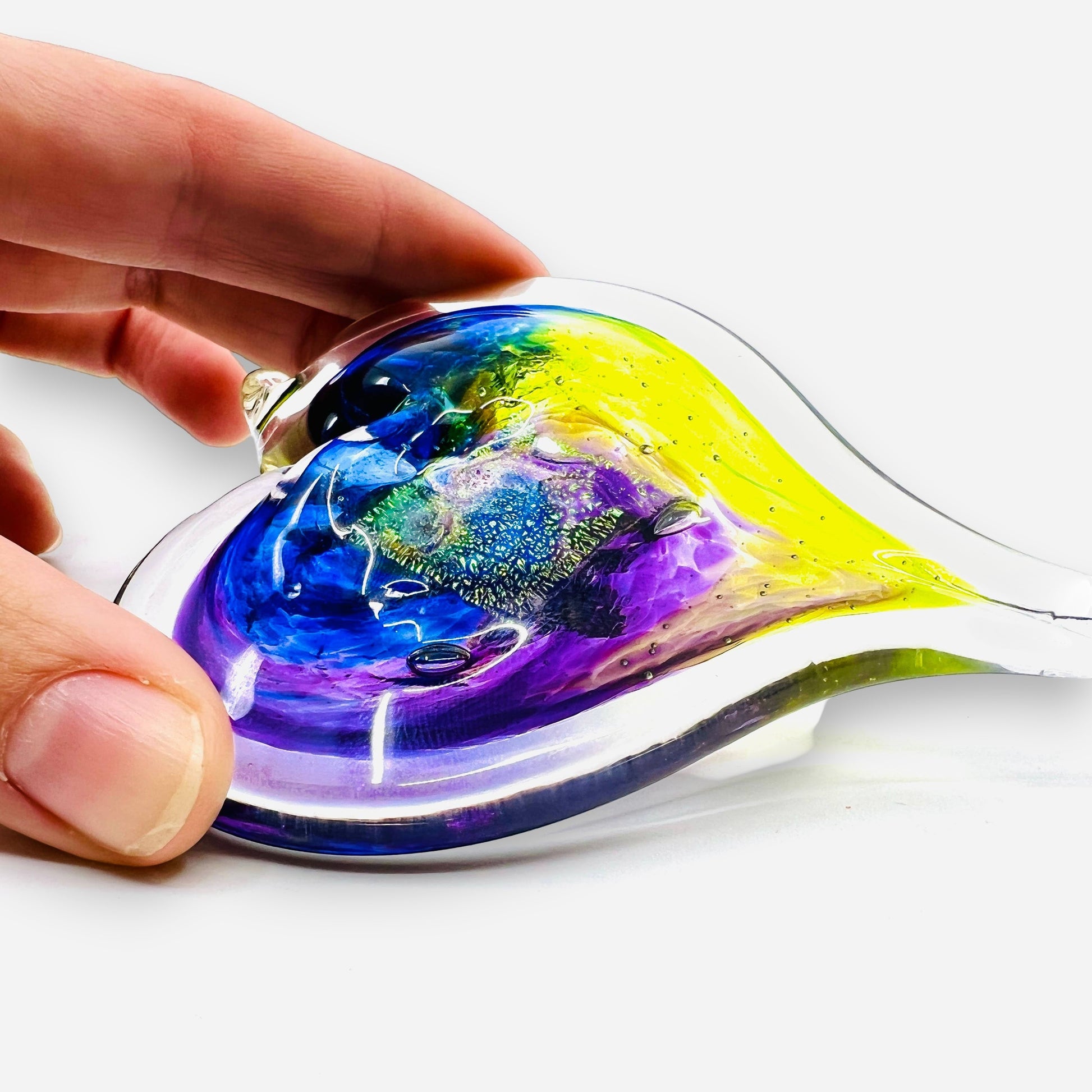 Mellow Monkey hand-blown glass heart ornament featuring vibrant blue, purple, and yellow swirls in a 3-inch size.