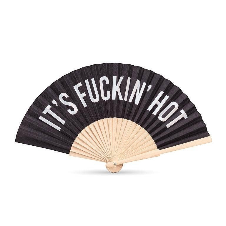 Mellow Monkey black cotton hand fan with white text reading 'IT'S F*CKIN' HOT' and wooden ribs.