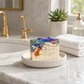 Mellow Monkey Deck The Halls handmade bar soap with colorful holiday light swirls on a white ceramic soap dish.