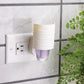Mellow Monkey Harmony WallScents fragrance warmer with a white textured cover plugged into a wall outlet.