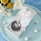Mellow Monkey heart-shaped stainless steel measuring spoons in a gift box with a white ribbon for a baby shower favor.