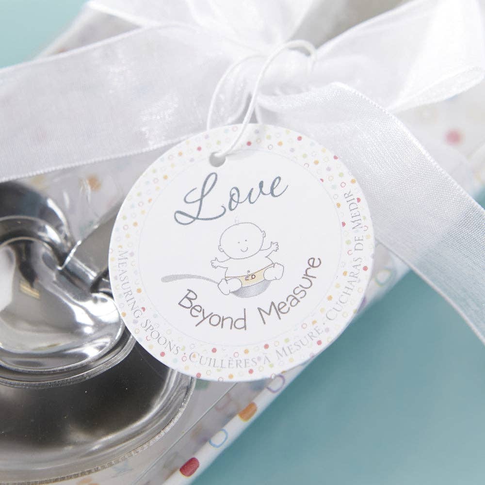 Mellow Monkey heart-shaped stainless steel measuring spoons tied with a white ribbon and baby shower gift tag