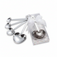 Mellow Monkey set of 4 stainless steel heart-shaped measuring spoons with engraved sentiments in a gift box