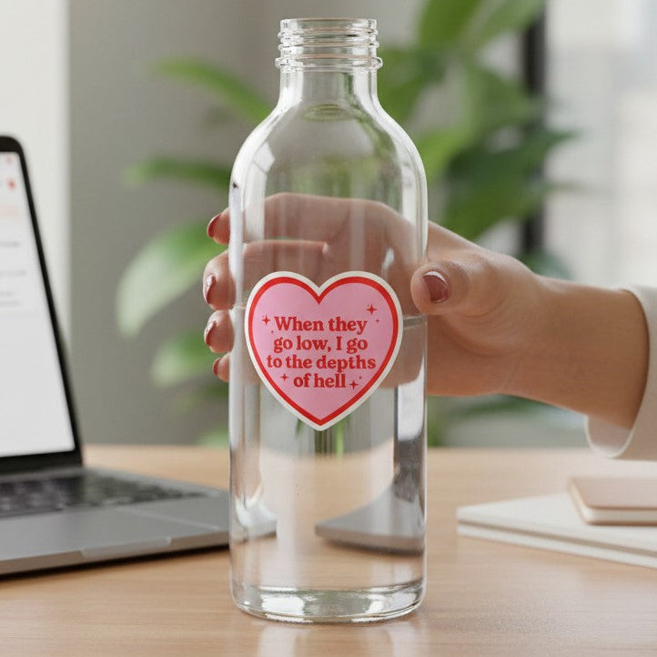 Mellow Monkey heart-shaped sticker with red text on a clear water bottle, featuring a bold, edgy quote.