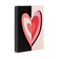 Mellow Monkey Love Together Tile Acrylic Wall Art, 5 x 7-in, featuring a layered heart design in shades of pink and red on a split black and light pink background.