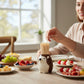 Mellow Monkey brown ceramic hedgehog toothpick holder on a table with appetizers and a woman reaching for a toothpick