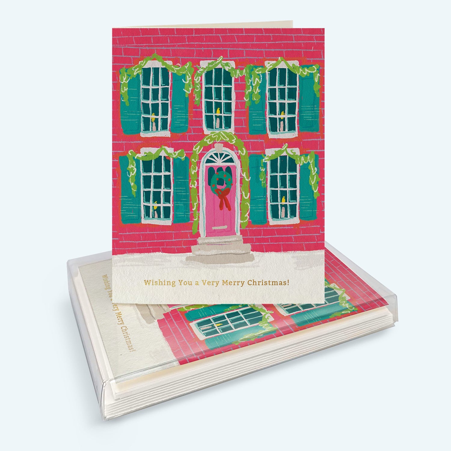 Mellow Monkey boxed holiday cards featuring a festive red brick house illustration with green shutters and wreath.