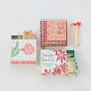 Mellow Monkey holiday matchboxes with retro graphics and coordinating colored matchsticks on a white background