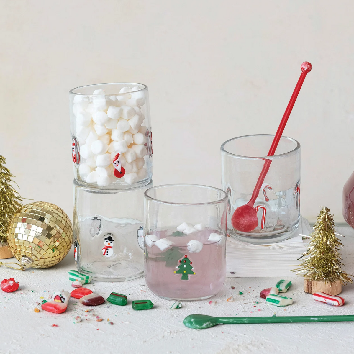 Mellow Monkey set of 4 clear 16 oz drinking glasses with festive holiday icons like snowmen, trees, and Santa.