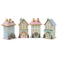 Mellow Monkey set of four handcrafted, glittery pastel holiday light-up houses with festive miniature trees.
