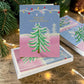 Mellow Monkey Holiday Spirit Tree boxed greeting cards featuring a festive pine tree illustration on a pink background