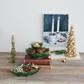 Mellow Monkey hand-painted green dolomite holly leaf footed trays with red berries displayed on a rustic table.