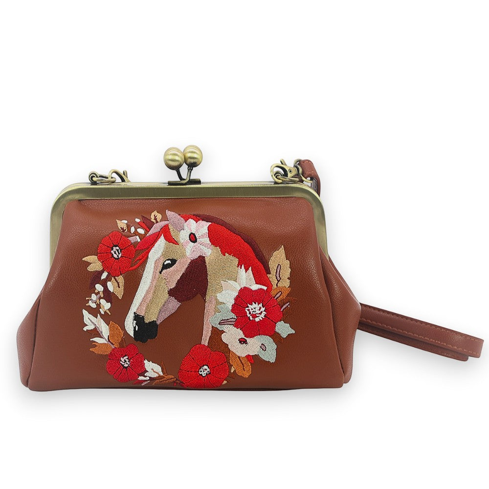 Mellow Monkey brown vinyl kisslock bag featuring an embroidered horse head framed by a vibrant floral wreath.