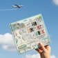 Mellow Monkey How Airports Work interactive lift-the-flap book for kids held against a blue sky with an airplane